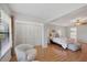 Spacious bedroom with hardwood floors, a ceiling fan, and closet space at 7374 Royal Birkdale Dr # 15D, Sarasota, FL 34238