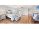 Large bedroom with hardwood floors, ceiling fan, and access to the bathroom at 7374 Royal Birkdale Dr # 15D, Sarasota, FL 34238