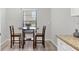 Cozy breakfast nook with wood floors and window at 7374 Royal Birkdale Dr # 15D, Sarasota, FL 34238