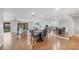 Open dining area with wood floors, table, and living room view at 7374 Royal Birkdale Dr # 15D, Sarasota, FL 34238