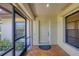 The screened front porch features a neutral color scheme and a covered area at 7374 Royal Birkdale Dr # 15D, Sarasota, FL 34238