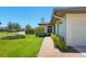 Home exterior with manicured lawn, neat landscaping, and a charming walkway at 7374 Royal Birkdale Dr # 15D, Sarasota, FL 34238
