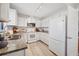 Bright kitchen with white cabinets, stainless appliances, and granite countertops at 7374 Royal Birkdale Dr # 15D, Sarasota, FL 34238