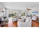 Bright and airy living room with hardwood floors, white armchairs, and a view of the backyard at 7374 Royal Birkdale Dr # 15D, Sarasota, FL 34238