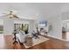 Inviting living room with wood floors, neutral walls, and a sliding glass door to the screened in porch at 7374 Royal Birkdale Dr # 15D, Sarasota, FL 34238