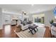 Bright and airy living room with wood floors, natural light, a fireplace, and sliding glass doors at 7374 Royal Birkdale Dr # 15D, Sarasota, FL 34238