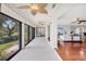 Bright sunroom with tile floors, ceiling fans and many windows showcasing lush views at 7374 Royal Birkdale Dr # 15D, Sarasota, FL 34238