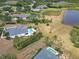 Aerial view of a backyard with a pool, mature trees, and privacy fence at 8121 Snowy Egret Pl, Bradenton, FL 34202
