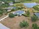 Aerial view of a well-maintained home with mature trees, landscaping, and a private pond at 8121 Snowy Egret Pl, Bradenton, FL 34202