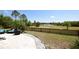 Backyard patio with seating and decorative rock border overlooking the lake at 8121 Snowy Egret Pl, Bradenton, FL 34202