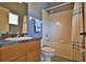 Well-maintained bathroom featuring a shower-tub combo and a oak vanity with laminate countertop at 8121 Snowy Egret Pl, Bradenton, FL 34202