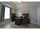 Cozy bedroom with wood-look floors, tray ceiling, and neutral paint at 8121 Snowy Egret Pl, Bradenton, FL 34202