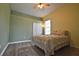 Bedroom features wood-look floors, a ceiling fan and a window for natural light at 8121 Snowy Egret Pl, Bradenton, FL 34202