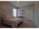 Neutral toned bedroom with wood look floors, a window and a large closet at 8121 Snowy Egret Pl, Bradenton, FL 34202
