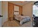Bedroom features a comfortable bed, wooden barn door style closet and accent shelving at 8121 Snowy Egret Pl, Bradenton, FL 34202