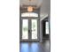 Bright entryway featuring double doors, transom window, and decorative light fixture at 8121 Snowy Egret Pl, Bradenton, FL 34202