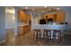 An eat-in kitchen with wooden cabinets and a three-chair breakfast bar at 8121 Snowy Egret Pl, Bradenton, FL 34202