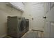 Functional laundry room with modern washer and dryer, ample storage, and easy access at 8121 Snowy Egret Pl, Bradenton, FL 34202