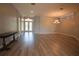 Open-concept living room with wood-look floors, recessed lighting, and neutral paint at 8121 Snowy Egret Pl, Bradenton, FL 34202