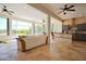 Bright living room featuring neutral decor, tile flooring, and dining and kitchen areas at 8121 Snowy Egret Pl, Bradenton, FL 34202
