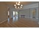 Bright living room boasting wood-look floors, recessed lights, and a modern chandelier at 8121 Snowy Egret Pl, Bradenton, FL 34202