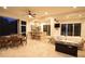Inviting covered outdoor patio with dining table, outdoor kitchen, and comfortable seating area at 8121 Snowy Egret Pl, Bradenton, FL 34202