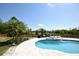 Pool with a water feature and a view of the lake from the patio at 8121 Snowy Egret Pl, Bradenton, FL 34202