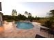 A private backyard with a luxurious pool and beautiful waterfall feature provides a tranquil and relaxing outdoor oasis at 8121 Snowy Egret Pl, Bradenton, FL 34202