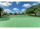 Well-maintained tennis court in a community setting with trees, playground, and shelter at 8121 Snowy Egret Pl, Bradenton, FL 34202