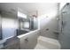 This bathroom features a shower, tile, and gray wood-look cabinets with double sinks at 8226 Sweden Blvd, Punta Gorda, FL 33982