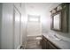 This bathroom features a shower-tub combo, gray cabinets, and wood-look floors at 8226 Sweden Blvd, Punta Gorda, FL 33982