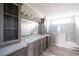 Bathroom features double sinks, granite countertops, decorative vanity, and a stand-up shower at 8226 Sweden Blvd, Punta Gorda, FL 33982