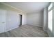 This bedroom has wood-look floors, a closet, and window with blinds at 8226 Sweden Blvd, Punta Gorda, FL 33982