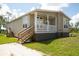 Inviting exterior of home with charming porch and well-maintained lawn at 8226 Sweden Blvd, Punta Gorda, FL 33982