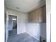 This mud room features wood-look floors, cabinets, and access to the bathroom at 8226 Sweden Blvd, Punta Gorda, FL 33982