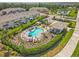 Aerial view of the community pool surrounded by lush landscaping and modern townhomes at 8545 Daybreak St, Sarasota, FL 34241