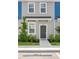 Charming townhome featuring a modern gray front door and nicely landscaped walkway at 8545 Daybreak St, Sarasota, FL 34241