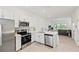 Open-concept kitchen with stainless steel appliances and views into the living room at 8545 Daybreak St, Sarasota, FL 34241