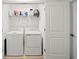 Laundry room featuring a washer, dryer, and overhead storage shelves at 8545 Daybreak St, Sarasota, FL 34241