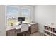 Bright home office with modern desk, large windows and a view at 8545 Daybreak St, Sarasota, FL 34241