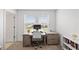 Well lit home office with large windows, a modern desk, and stylish decor at 8545 Daybreak St, Sarasota, FL 34241