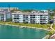 Beautiful waterfront condos featuring a well-manicured lawn, private boat docks, and water views at 8911 Midnight Pass Rd # 308, Sarasota, FL 34242