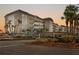 Beautiful condo building with covered parking, lush landscaping, and private balconies at 8911 Midnight Pass Rd # 308, Sarasota, FL 34242
