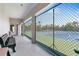 View of well-maintained tennis courts through the community's shaded viewing area on a sunny day at 8911 Midnight Pass Rd # 308, Sarasota, FL 34242