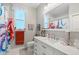 Bright bathroom with large mirror, decorative shower curtain, and unique fixtures at 9012 Province St, Sarasota, FL 34240