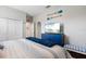 Bedroom with a blue dresser, large TV, paddles, and a comfortably made bed with blue accents at 9012 Province St, Sarasota, FL 34240
