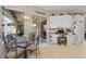 Bright dining area features a glass table, workspace, and sliding glass doors to the outdoor patio at 9012 Province St, Sarasota, FL 34240