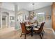 Elegant dining room featuring a glass-top table, comfortable seating for six, and modern chandelier at 9012 Province St, Sarasota, FL 34240