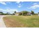 Beautiful home with a well-manicured front lawn and mature palm trees at 9012 Province St, Sarasota, FL 34240