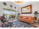 Cozy living room with a stylish rug, comfortable seating, and sliding glass doors leading to the pool area at 9012 Province St, Sarasota, FL 34240